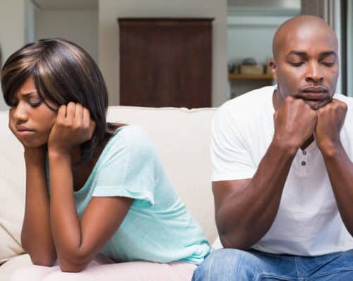 A couple mad at each other in the living room