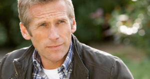 A middle-aged man smiles peacefully.