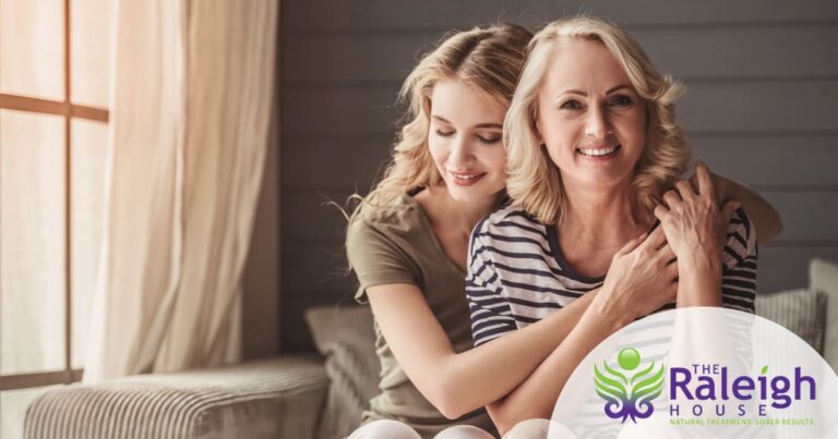 An adult daughter hugs her mom.