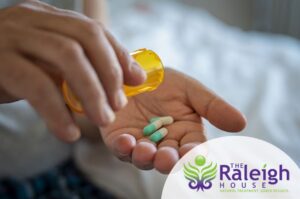 Close-up of a man pouring painkillers into his hand.