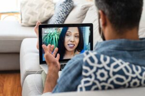 A man in recovery attending an online support meeting at home.