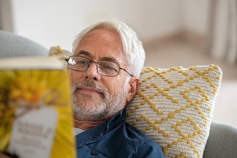 A man coping with depression and anxiety by reading a book.