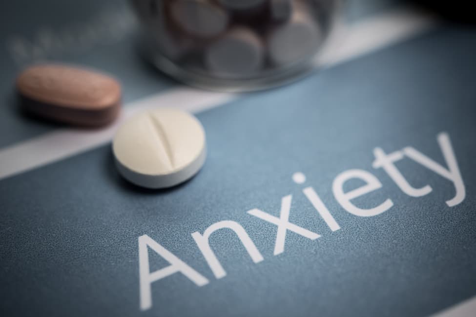 Prescription pills on a table above the word
