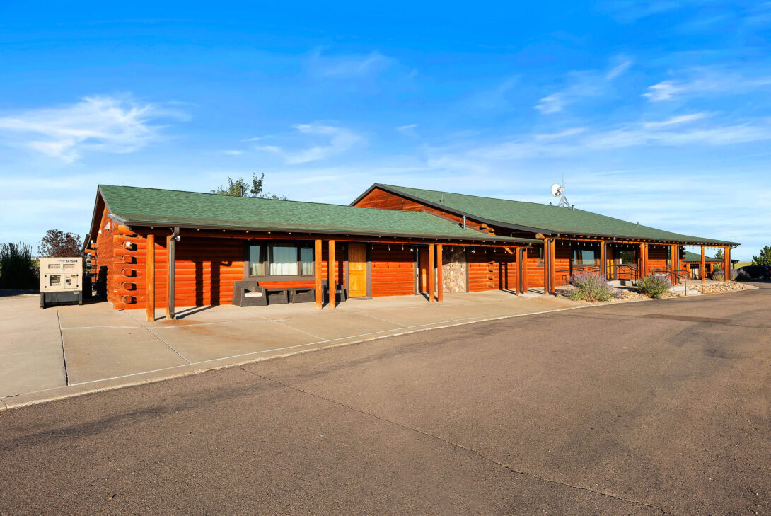 Blue skies over the log building at The Ranch