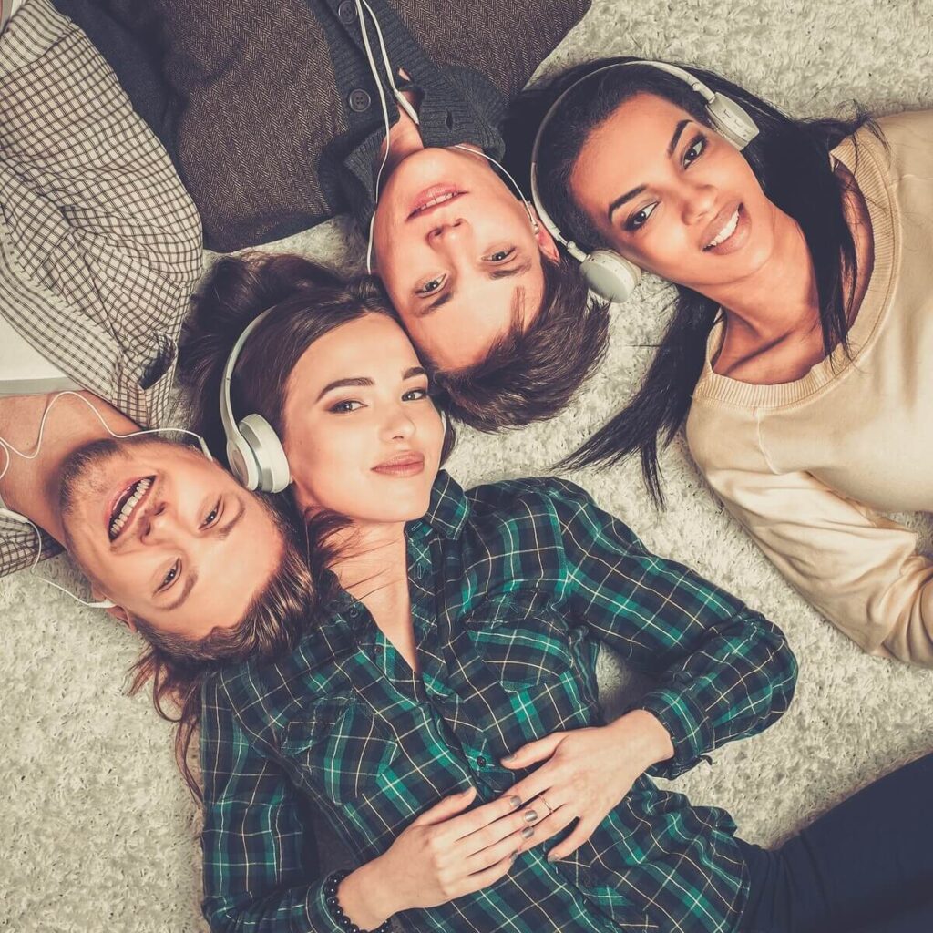 friends listening to music together on the floor