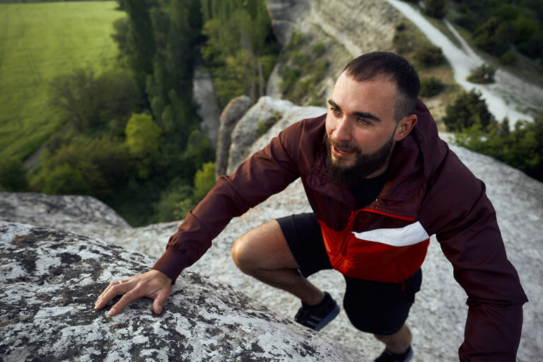 Young man climbing rocks