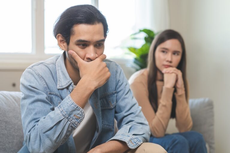 Man upset while talking on a couch