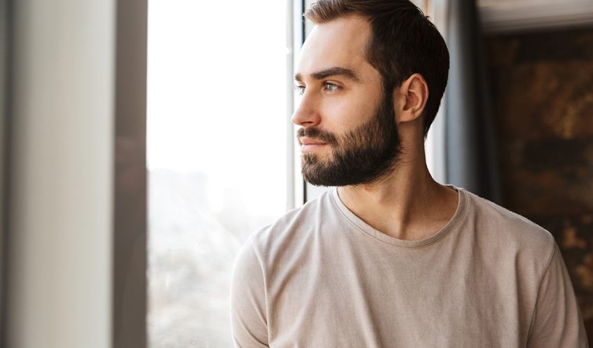 Young man staring out the window